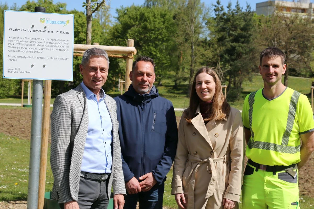 Bürgermeister Christoph Böck mit den städtischen Beschäftigten Florian Schmid (Grünplanung) Jasmin Lerch (Klimaschutz) und Steven Jahn (Servicebetrieb Stadtwerke) vor dem anlässlich der Neupflanzung aufgestelltem Schild. (Bild: Stadt Unterschleißheim)